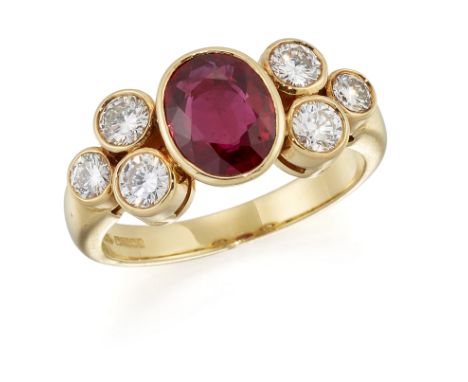 AN 18 CARAT GOLD RUBY AND DIAMOND RING, an oval-cut ruby in a bezel setting, spaced by groups of three round brilliant-cut di