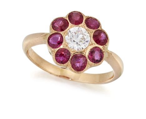 A DIAMOND AND RUBY CLUSTER RING, an old-cut diamond within a border of round-cut rubies, to tapered shoulders, estimated diam