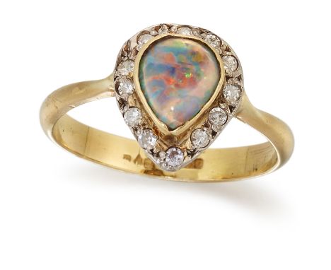 AN 18 CARAT GOLD BLACK OPAL AND DIAMOND CLUSTER RING, a pear cabochon black opal in a bezel setting within a border of eight-