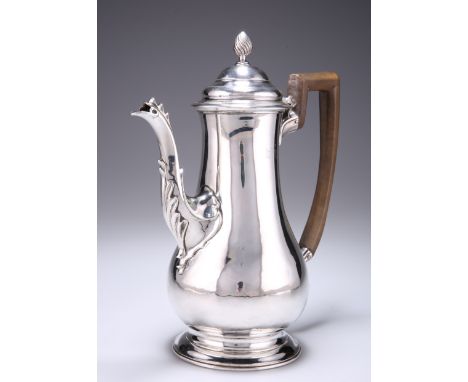 A GEORGE III SILVER COFFEE POT, by Walter Brind, London 1769, pear-shaped, the hinged domed cover with wrythen finial, the sp