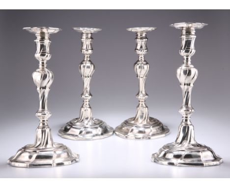 A SET OF FOUR GEORGE II CAST SILVER CANDLESTICKS, maker J.W (possibly James Wilks), London 1754, of knopped baluster form wit