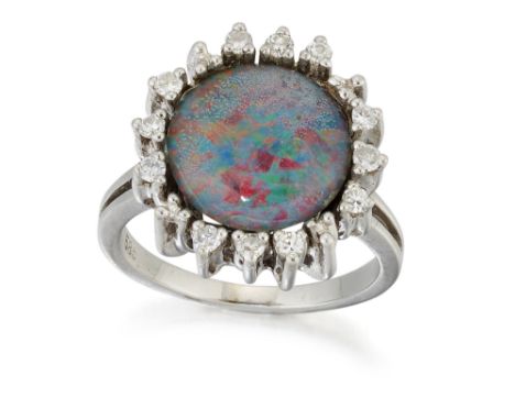 AN OPAL TRIPLET AND DIAMOND CLUSTER RING, a round opal triplet in a claw setting and within a border of round brilliant-cut d