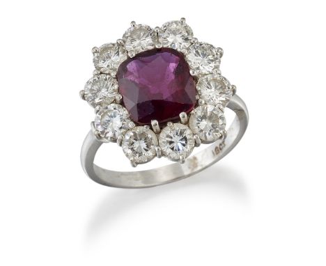 A RUBY AND DIAMOND CLUSTER RING, a cushion-cut ruby in a claw setting within a border of round brilliant-cut diamonds, to for