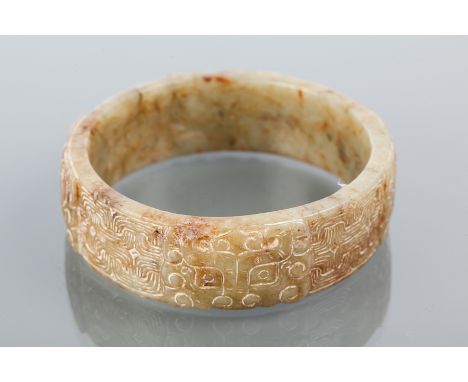 CARVED GREEN HARDSTONE BANGLE
carved to depict stylised dragon faces, 7cm diameter