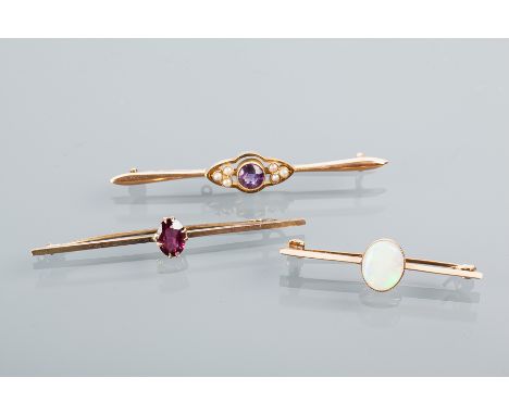 GROUP OF THREE EARLY TWENTIETH CENTURY BAR BROOCHES
comprising of a fifteen carat gold amethyst and seed pearl bar brooch, a 