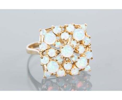 SYNTHETIC OPAL CLUSTER RING
the pierced square bezel set with cabochon opals, in silver gilt, size R-S