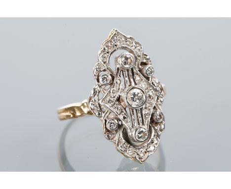 ORNATE DIAMOND CLUSTER RING
of pierced design, with three central brilliant cut diamonds surrounded by smaller diamonds, mark