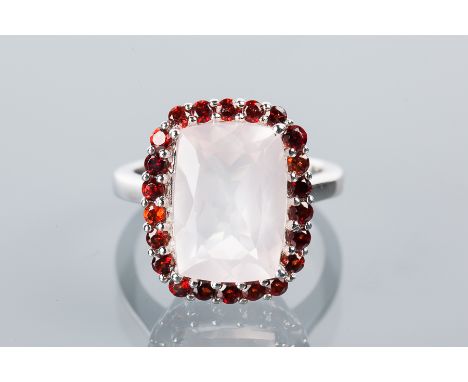 ROSE QUARTZ AND GARNET CLUSTER RING
with a large cushion cut quartz surrounded by garnets, in silver, marked 925, size N-O
