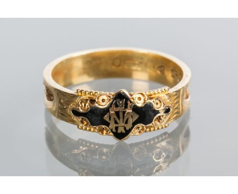 VICTORIAN MOURNING RING
enamelled in black with monogram decoration, with hairwork panels, hallmarked for fifteen carat gold,