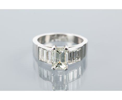 IMPRESSIVE DIAMOND DRESS RING
the central emerald cut diamond of approximately 1.50 carats on channel set baguette cut diamon