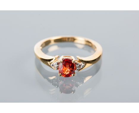 DIAMOND AND RUBY SET CLUSTER RING
the central red oval cut ruby flanked by two brilliant cut diamonds, hallmarked nine carat 