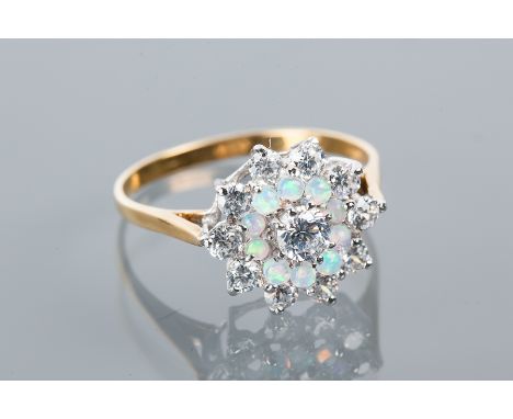 SYNTHETIC OPAL AND CZ CLUSTER RING
with a central white CZ, surrounded by synthetic opals, and further surrounded by white CZ