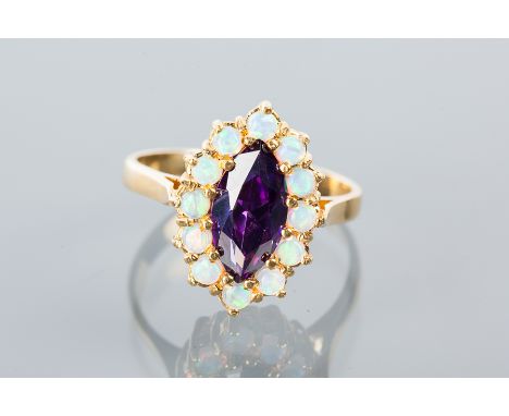 SYNTHETIC OPAL AND AMETHYST CLUSTER RING
with a central marquise shaped amethyst surrounded by synthetic opals, in silver gil