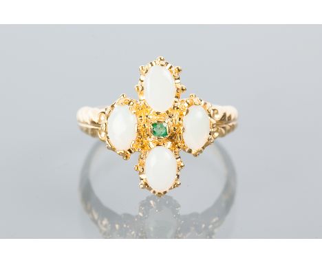 SYNTHETIC OPAL AND EMERALD RING
set with four oval cabochon synthetic opals, and a central round emerald, in silver gilt, siz