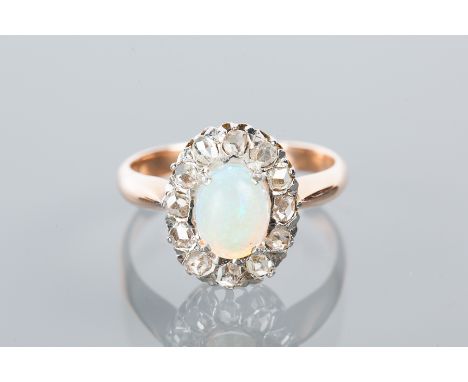 OPAL AND DIAMOND CLUSTER RING
with a central oval cabochon cut opal surrounded by rose cut diamonds, unmarked, size N-O