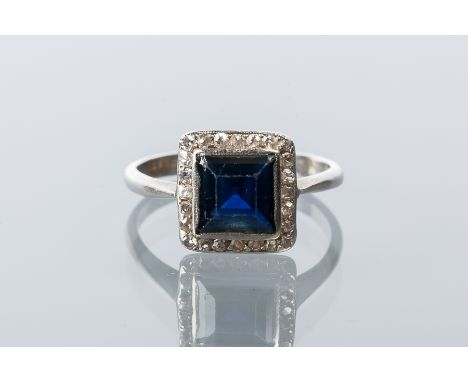 ART DECO SAPPHIRE AND DIAMOND RING
the central square step cut sapphire 6.6mm across, surrounded by old cut diamonds, in plat