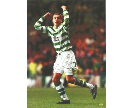 Football Henrik Larsson signed 12x8 colour magazine photo pictured while playing for Celtic. Good Condition. All autographs a