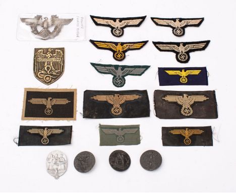 A German Police Shako badges, together with a group of four Totes, a Warsaw shield and a collection of German army cloth patc