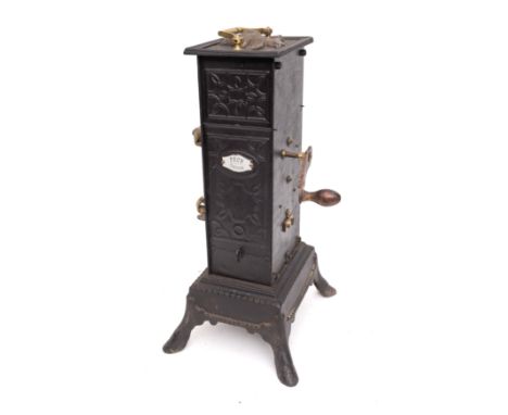 A 19th Century French clockwork spit engine in blackened tin and metal casing, the top with raised figure of a bird, with bra
