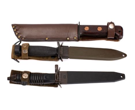 A NATO Type-D Fighting Knife,  the blackened single edge blade over a oval hilt and two piece wooden grip stamped  with broad