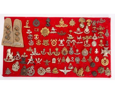 A collection of British and Colonial Army Regimental cap badges, including 18th Bengal Lancers, 11th Sikhs, 10th Goorkhas, Qu