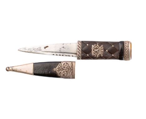 A silver mounted Skein dhu,   the short blade mounted in a bog oak grip with interlaced decoration and applied monogram, Celt