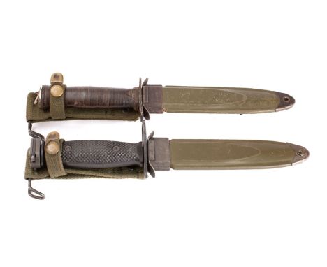 Two US M4 pattern fighting knives, one with rectangular hilt and wooden grip, the other with blackened blade, ring hilt and c