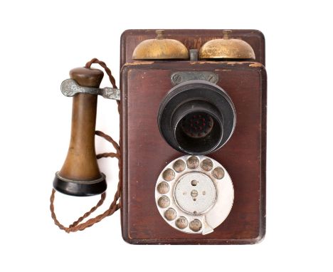 An early 20th century mahogany wall mounted No.121 pattern telephone: double brass bells over black Bakelite mouthpiece and r