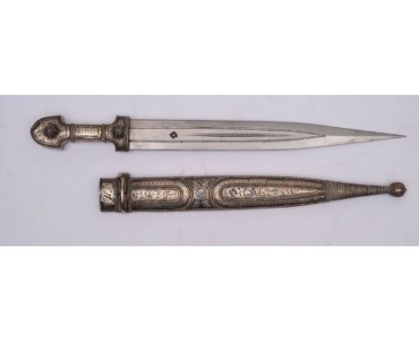 A white-metal  mounted jambiya, the straight double edge blade with fuller, over a traditional style grip with niello and wri