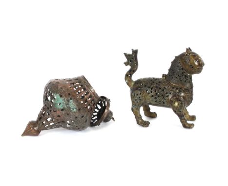 A 19th Century tinned copper mosque lamp; and a bronze figure of a cat, the body decorated with pierced foliate decoration an