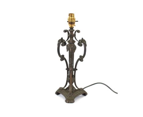 A bronze table lamp, having ram's head mask decoration and Corinthian column, raised on a triform base, 37cm high overall