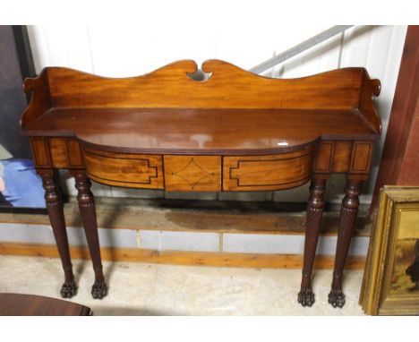 A George IV mahogany tray top wall standing serving table, of bow fronted form, fitted two drawers and raised on turned flute