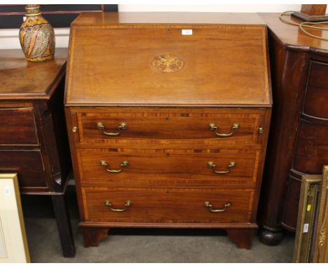 An Edwardian inlaid mahogany and satinwood cross-banded bureau, the fall front opening to reveal a fitted interior, three lon