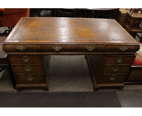 A walnut knee-hole pedestal writing desk, leather inset top fitted three frieze drawers with three drawers to each of the ped