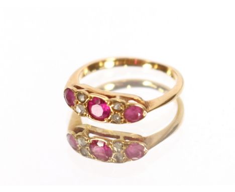 A yellow metal ruby and diamond set ring