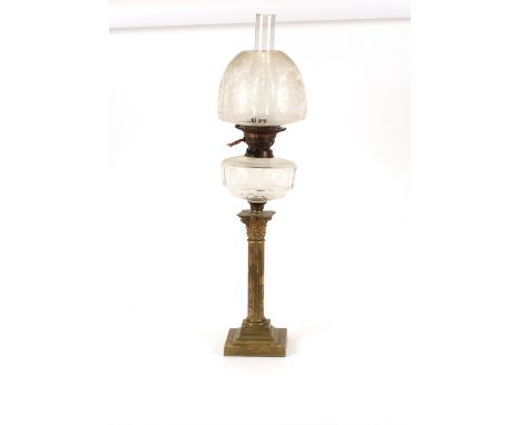 A brass Corinthian column table oil lamp, having etched glass shade, later converted to electricity, 52cm high