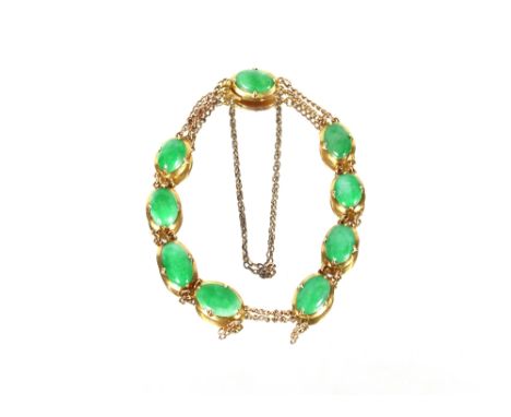 A Chinese yellow metal bracelet, set with oval jade stones