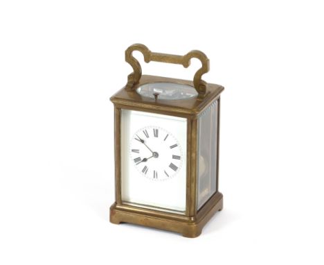 A brass cased striking carriage clock, with repeat button and angular swing handle, 17cm high overall