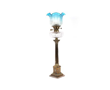 A plated Corinthian column oil lamp, having hob-nail cut reservoir and etched blue tinted shade, 90cm high overall