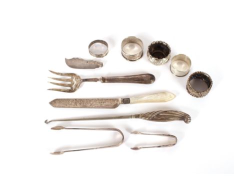 A Victorian silver serving fork; a silver bladed and mother of pearl handled cake knife; three various napkin rings; a pair o