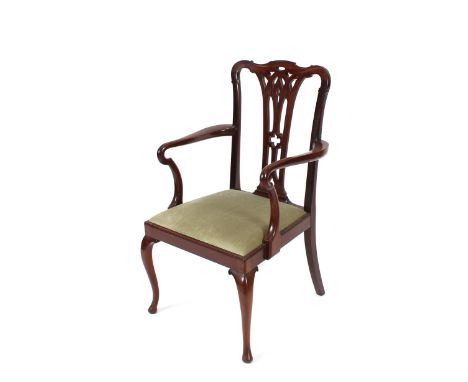 A set of eightmahogany Chippendale style dining chairs, having pierced splat backs, green dralon upholstered seats, raised on