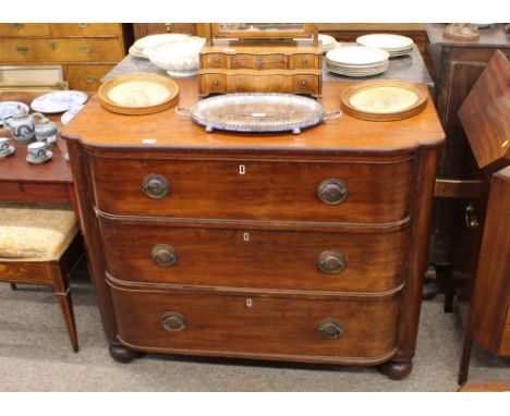 A 19th Century mahogany bow fronted chest, fitted three long drawers and raised on bun feet, 114cm wide