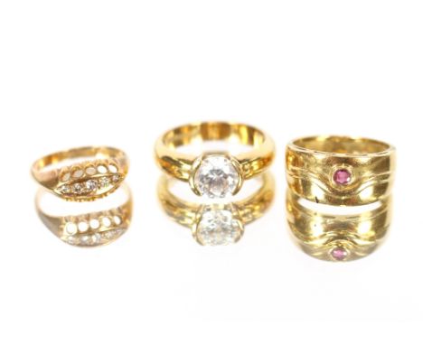 A ruby set 18 carat gold ring;&nbsp; a three stone diamond set 18 carat gold ring and a large crystal yellow metal set ring, 