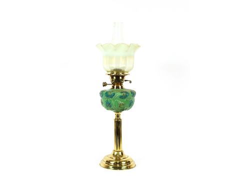 A Victorian brass column oil lamp, having opaque floral reservoir and Vaseline glass shade, 69cm high&nbsp; overall