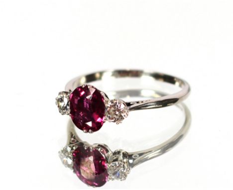 A diamond and ruby three stone ring