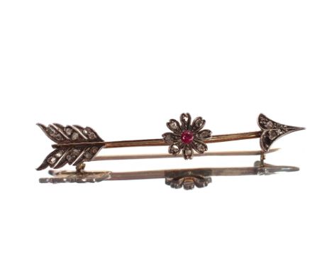 An arrow brooch, set diamonds and central flower motif with red stone