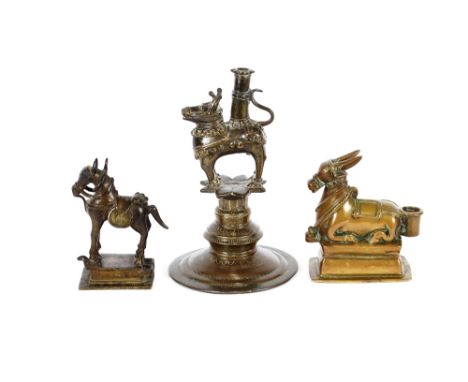 An 18th Century Indian bronze figure of a recumbent Nandi bull, 13cm long;&nbsp;another on circular stepped base formed as a 