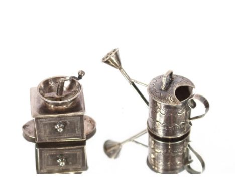 A 19th Century Continental white metal miniature watering can, 5.8cm long overall; and a 19th Century Continental miniature w