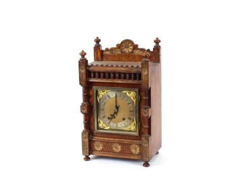 A late Victorian oak mantel clock, in architectural style case, with brass spandrel dial and steel chapter ring, 8 day moveme