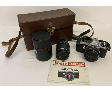 A Pentax ME Asahi 35mm camera with 40mm lens and a cased 135mm lens.  Complete with instruction booklet and a vintage leather